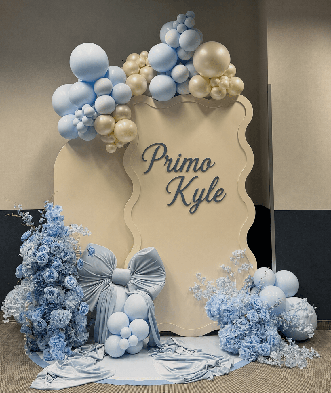Primo Kyle's baby boy christening with blue bow backdrop and soft blue florals